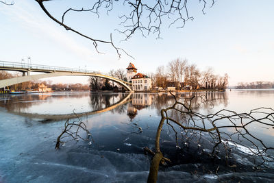 Bridge over river against sky during winter