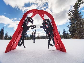 Snowshoes standing in snow against of snowy hills and mountains. winter walks in mountains.