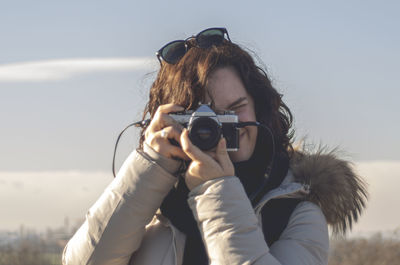 Portrait of woman photographing