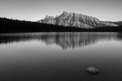 Scenic view of lake and mountains against clear sky