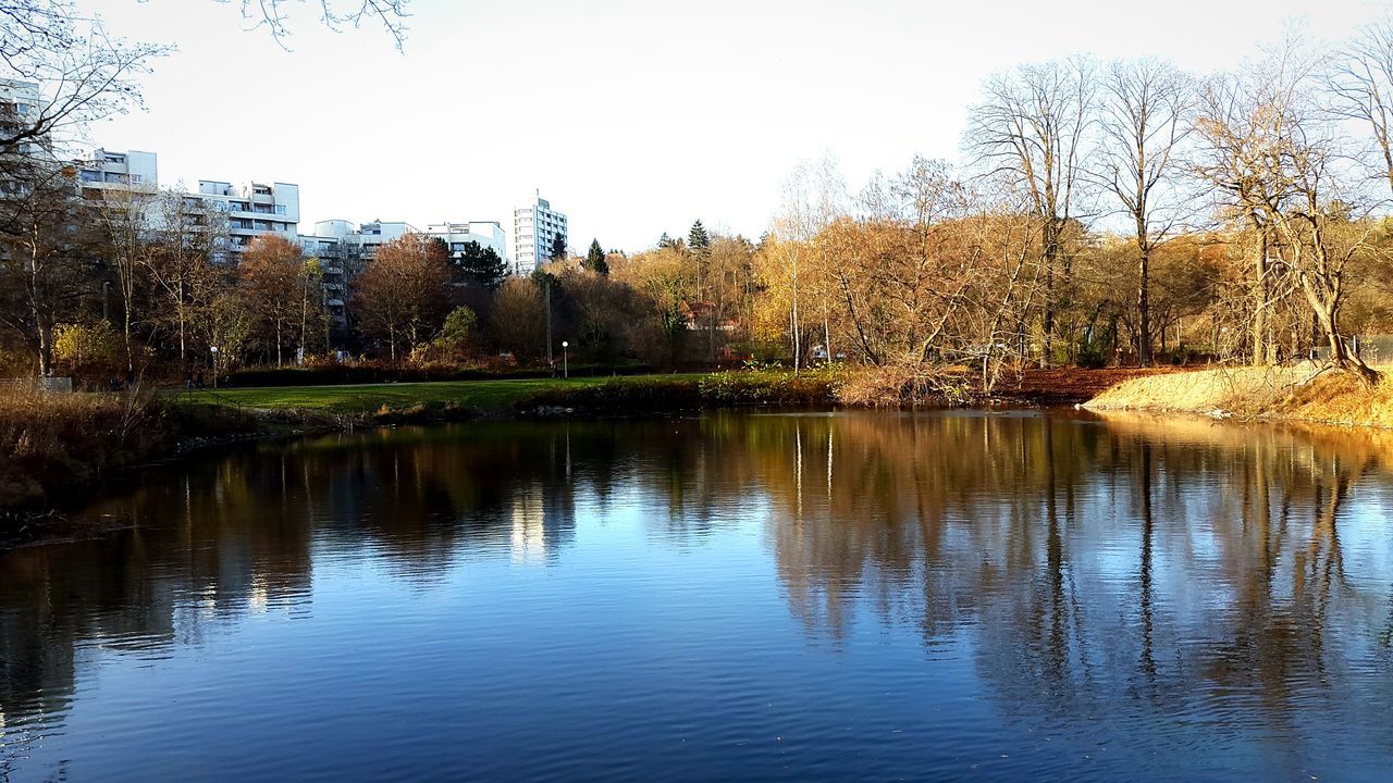 water, tree, building exterior, architecture, built structure, reflection, clear sky, waterfront, lake, river, tranquility, house, nature, tranquil scene, sky, day, city, outdoors, bare tree, growth