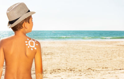 Portrait of young woman standing at beach