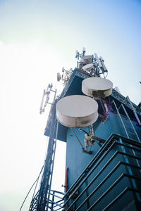 Low angle view of communications tower against sky