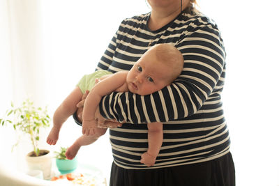 Midsection of woman holding teddy bear