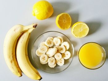 Directly above shot of bananas and lemon on table