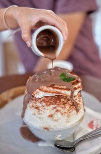 Close-up of hand holding ice cream