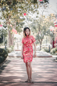 Full length portrait of girl on footpath