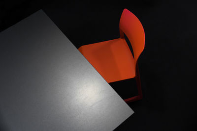 High angle view of table and chair against black background