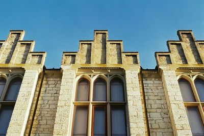 Low angle view of historical building against blue sky