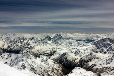 Scenic view of snow covered mountains against sky