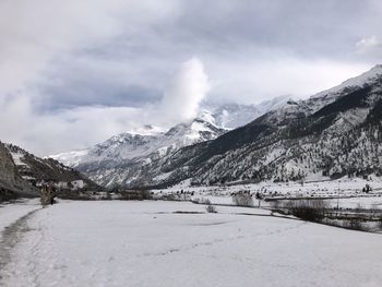 Scenic view of snowcapped mountains against sky