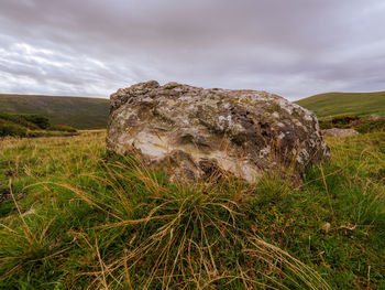 Scenic view of rocks on field against sky