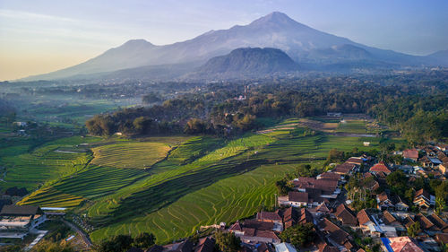 High angle view of townscape and mountains against sky