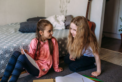 Side view of mother and daughter at home