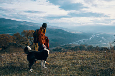 Horse standing on field against mountains