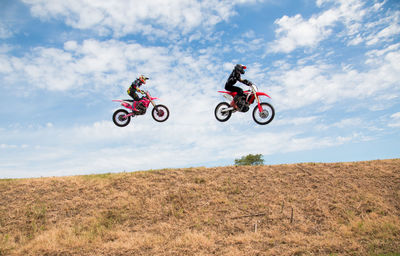 Motocross racers jumping