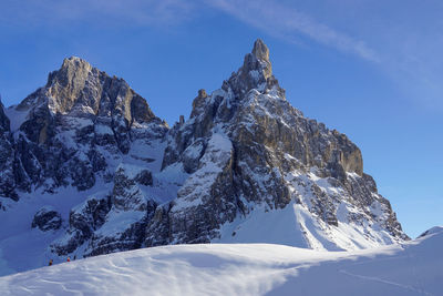 Scenic view of snowcapped mountains against blue sky