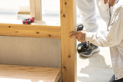 Midsection of man working at workshop