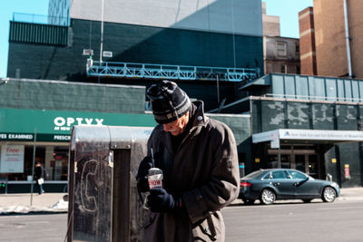 Full length of man using smart phone on street