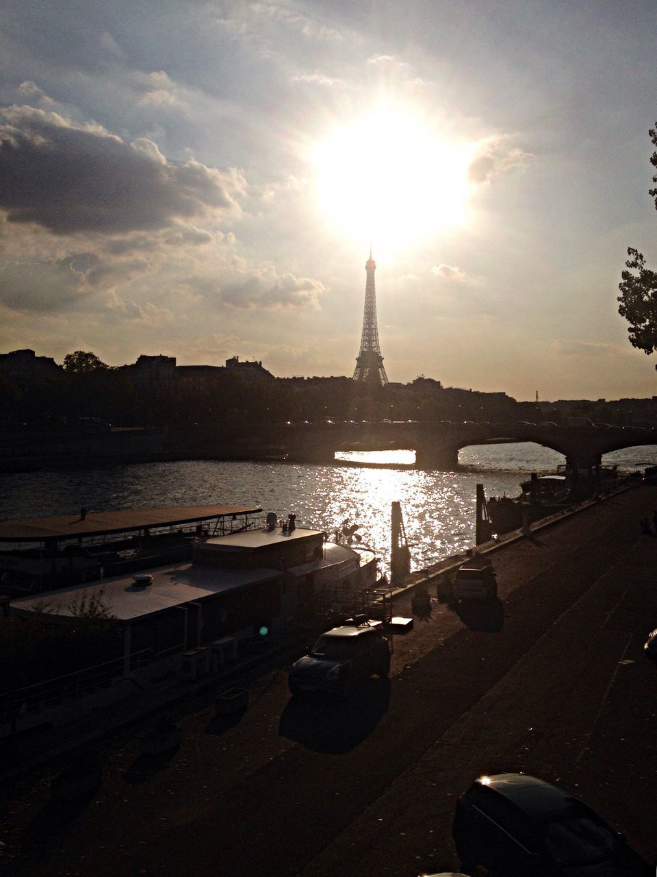 sun, water, sky, sunlight, architecture, sunbeam, building exterior, built structure, transportation, river, city, sunset, mode of transport, lens flare, reflection, cloud - sky, nautical vessel, outdoors, nature, no people