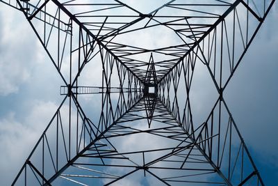 Low angle view of electricity pylon against sky
