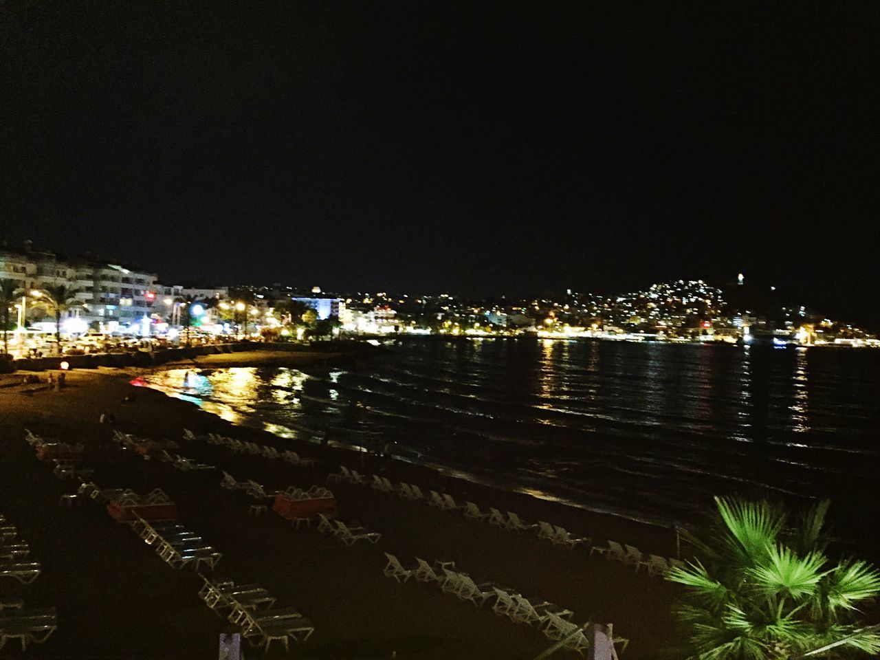 night, illuminated, built structure, architecture, water, building exterior, city, clear sky, copy space, river, bridge - man made structure, cityscape, sea, connection, reflection, lighting equipment, sky, high angle view, outdoors, bridge