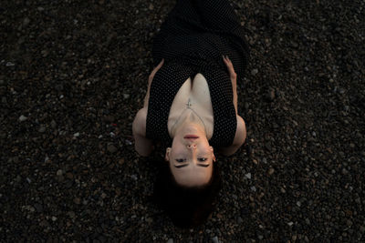 High angle view of seductive woman leaning at beach