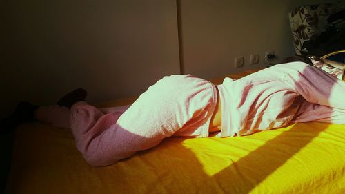 Man lying down on bed at home