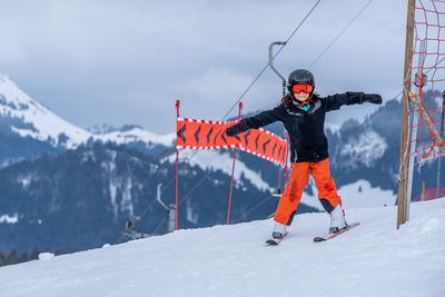 Full length of girl skiing on snow