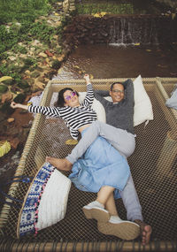 High angle view of couple lying outdoors