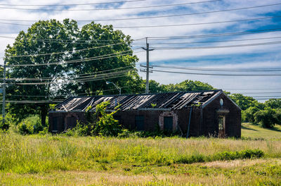 Scenic view of grassy field against cloudy sky