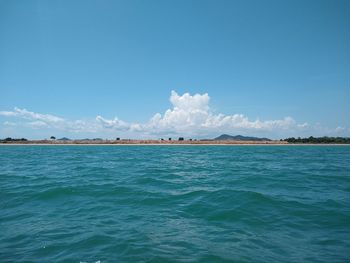 Scenic view of sea against blue sky