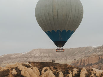 View of hot air balloon flying over rocks