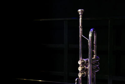 Close-up of illuminated electric lamp against black background