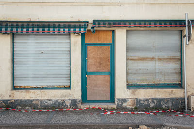 Closed window of old building. closed door of abandoned shop 