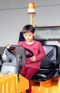 Boy sitting on cleaning vehicle