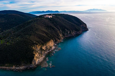 High angle view of sea and mountains against sky