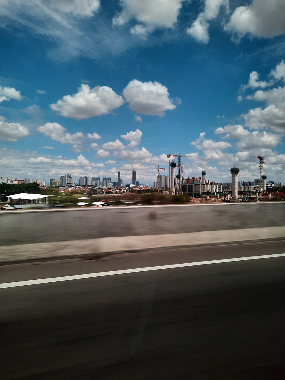 VIEW OF CITY AGAINST CLOUDY SKY