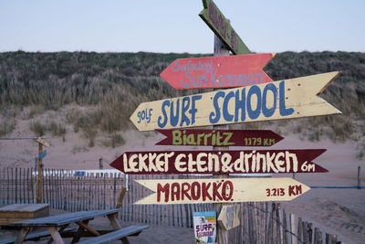 Information sign on road against sky