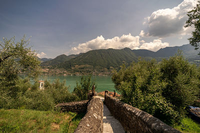 Scenic view of lake by mountains against sky