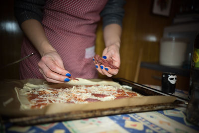 Midsection of man preparing food in kitchen