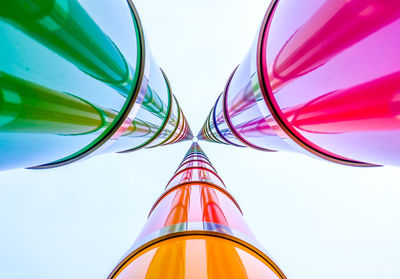 Low angle view of multi colored poles against sky