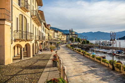 Street amidst buildings in city against sky