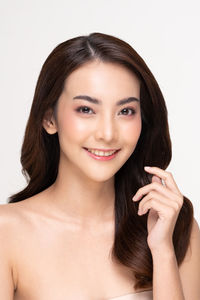 Portrait of a smiling young woman over white background