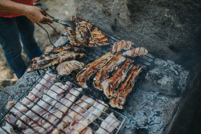 High angle view of meat on barbecue grill