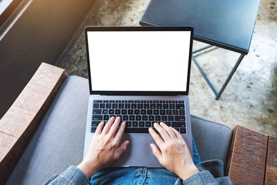 Midsection of woman using laptop