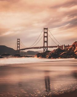 View of suspension bridge against cloudy sky