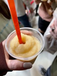 Close-up of hand holding slushee 