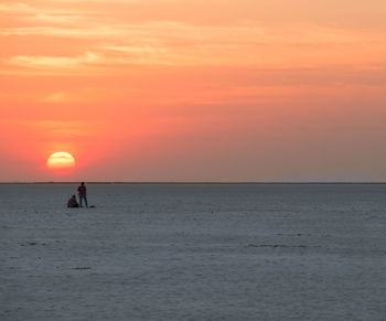 Scenic view of sea against orange sky