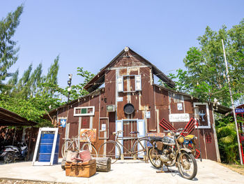 Bicycle by building against sky